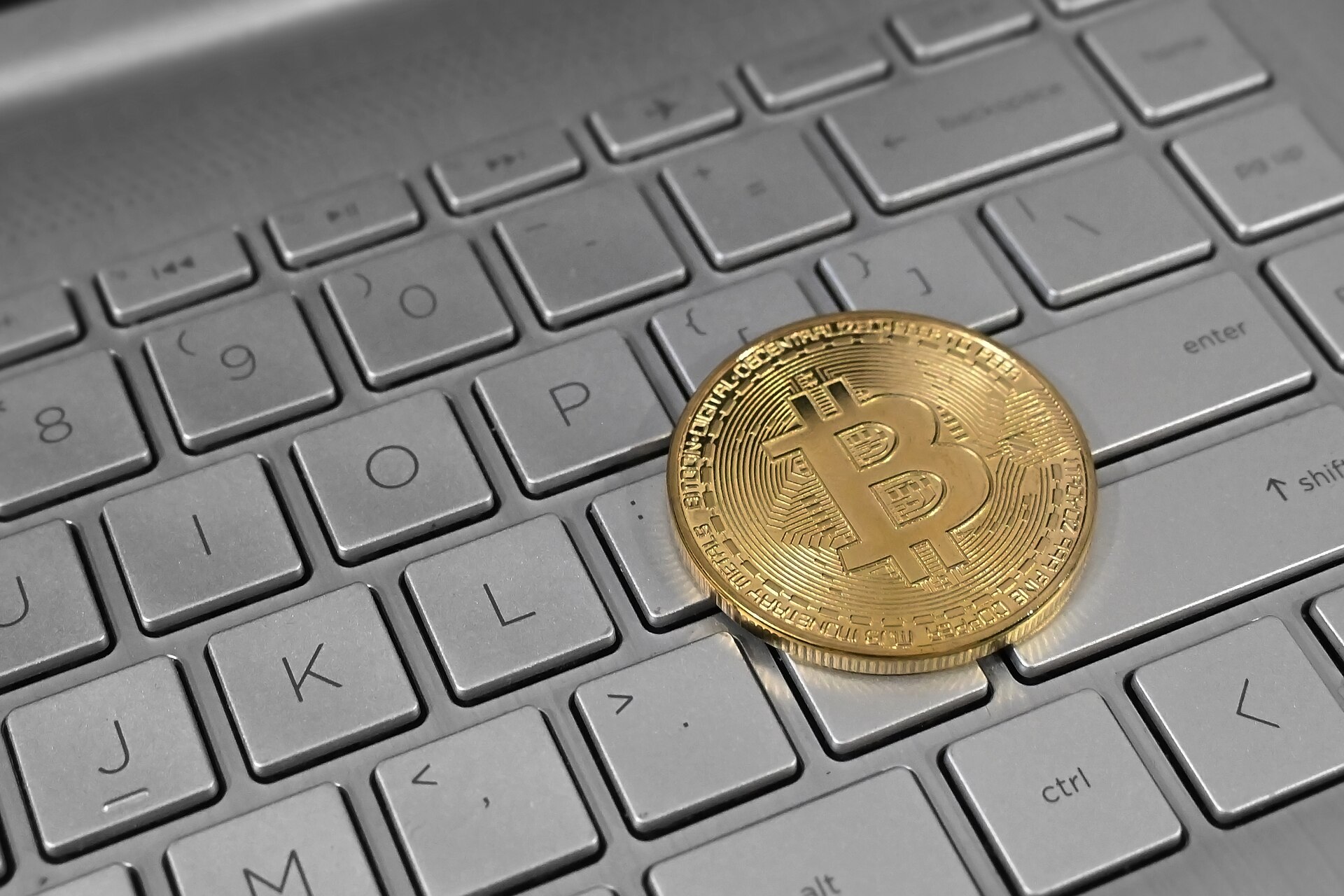 Physical bitcoin token on a laptop keyboard